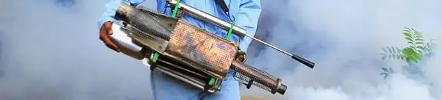 Fumigation technician using a fogger for deep pest treatment in Columbia, MO